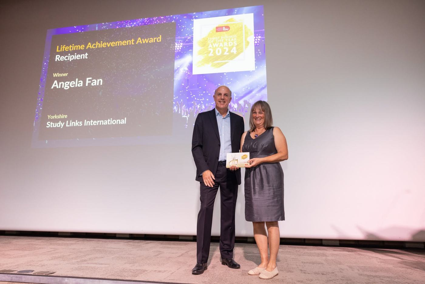 Angela Fan receiving a Lifetime Achievement Award on stage