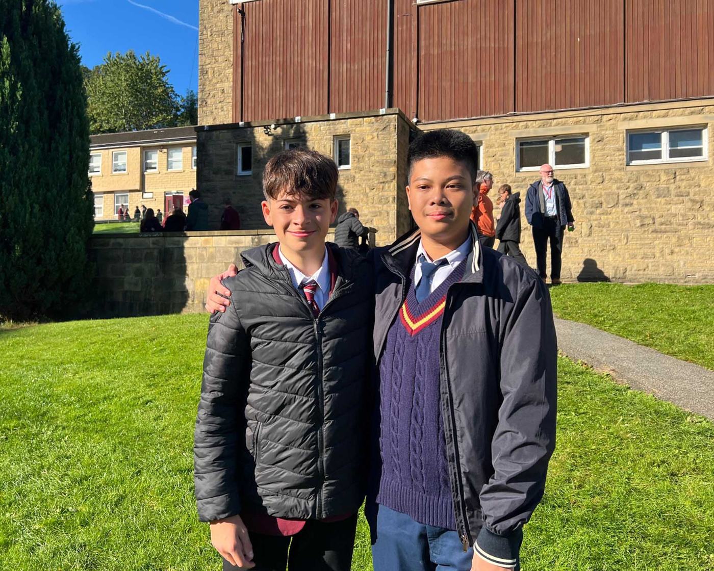 Two students in school uniform outside their UK boarding school