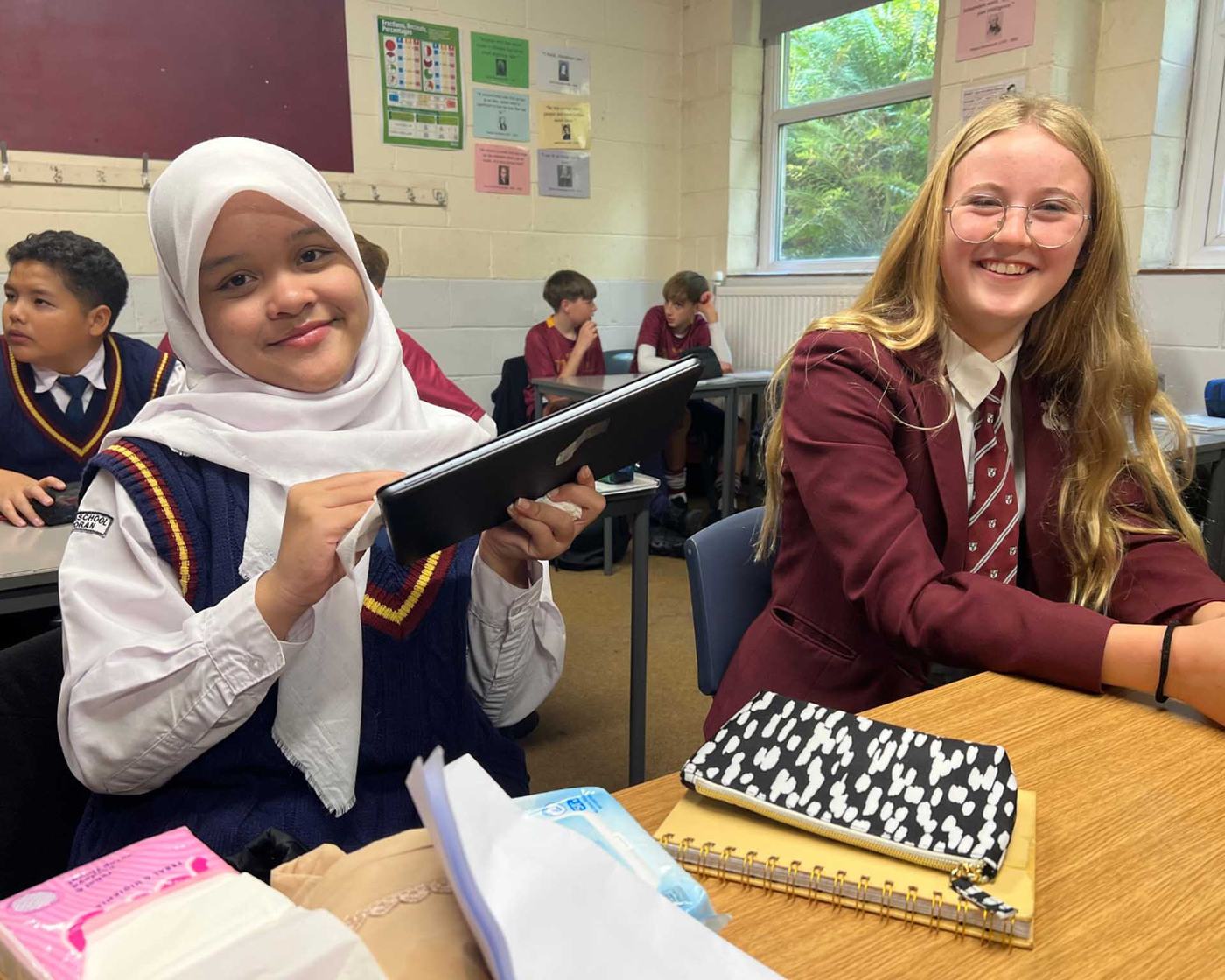 Students smiling in a UK school classroom